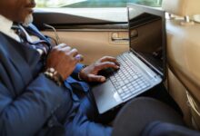 Business executive working on laptop in modern office environment