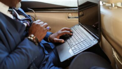 Business executive working on laptop in modern office environment