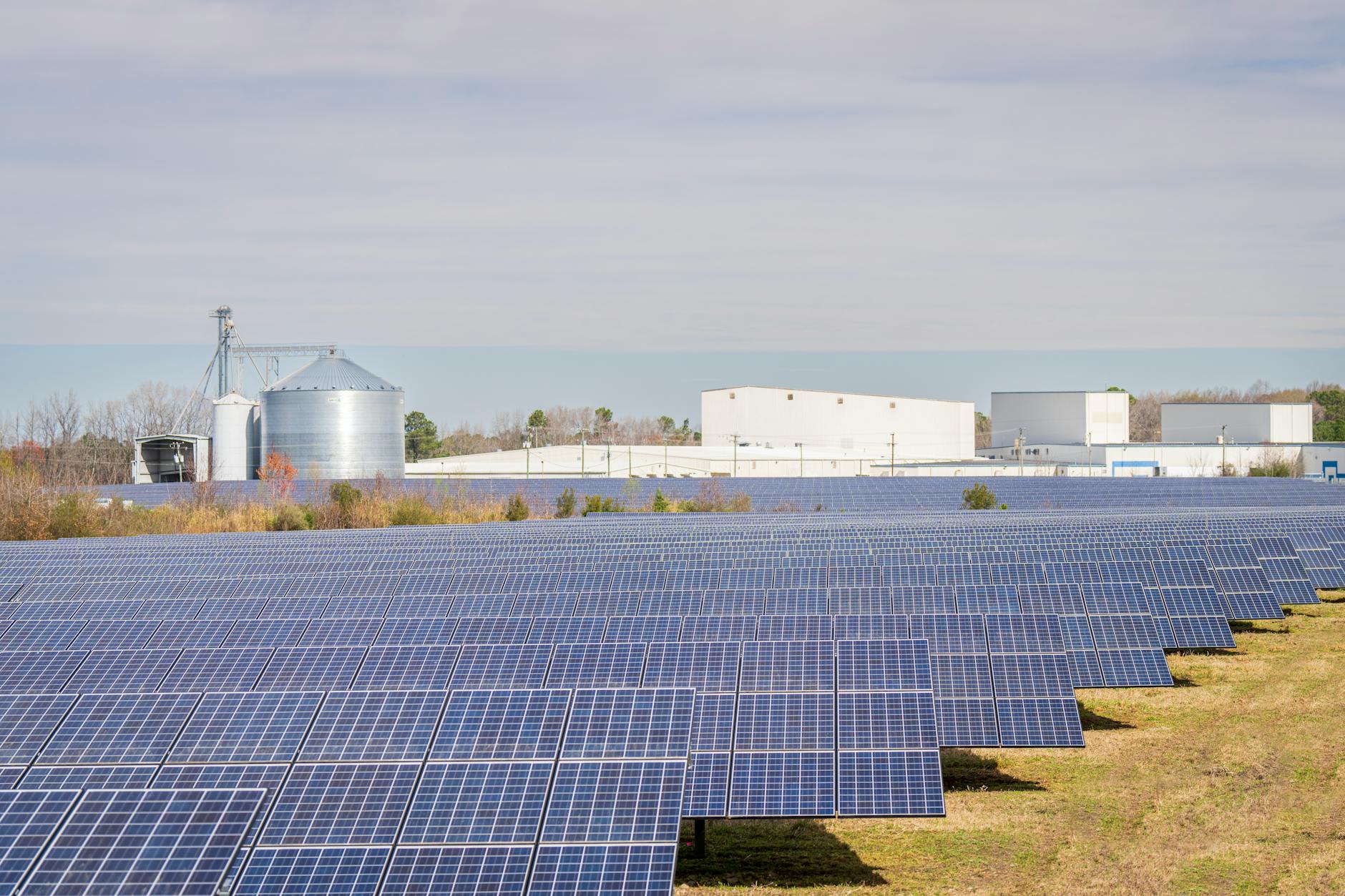 Solar panels floating on water reservoir surface with clear blue sky
