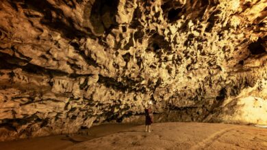 Underground cave chamber with stalactites and rock formations