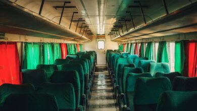 Elegant vintage train car interior with polished wood paneling and panoramic windows