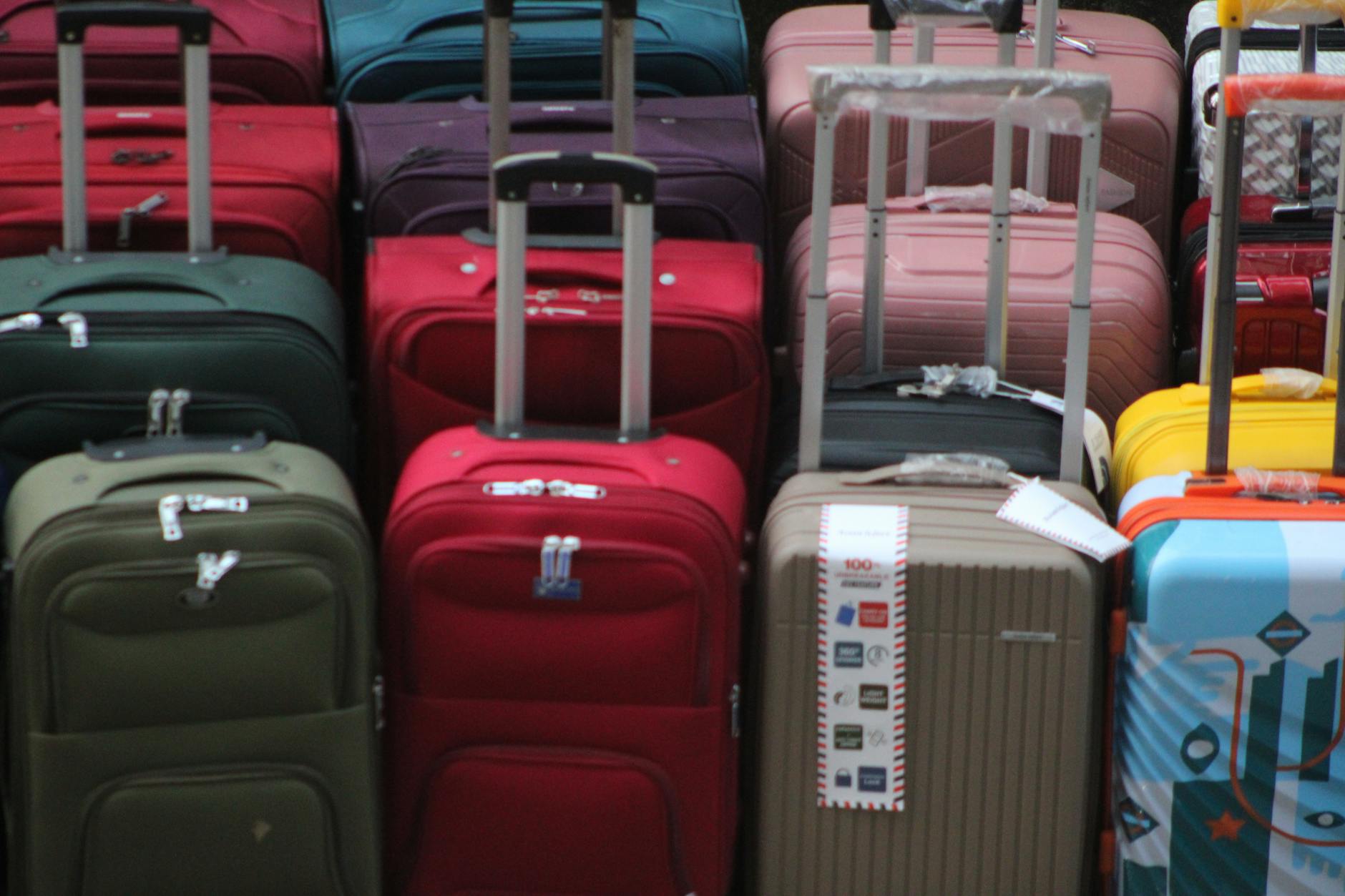 Black suitcase on airport luggage cart with terminal background