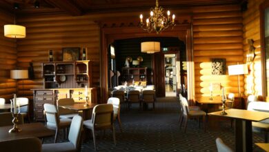Interior view of an ice hotel with carved ice furniture and atmospheric lighting