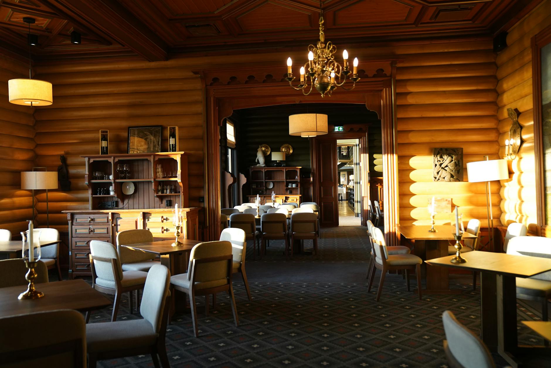 Interior view of an ice hotel with carved ice furniture and atmospheric lighting