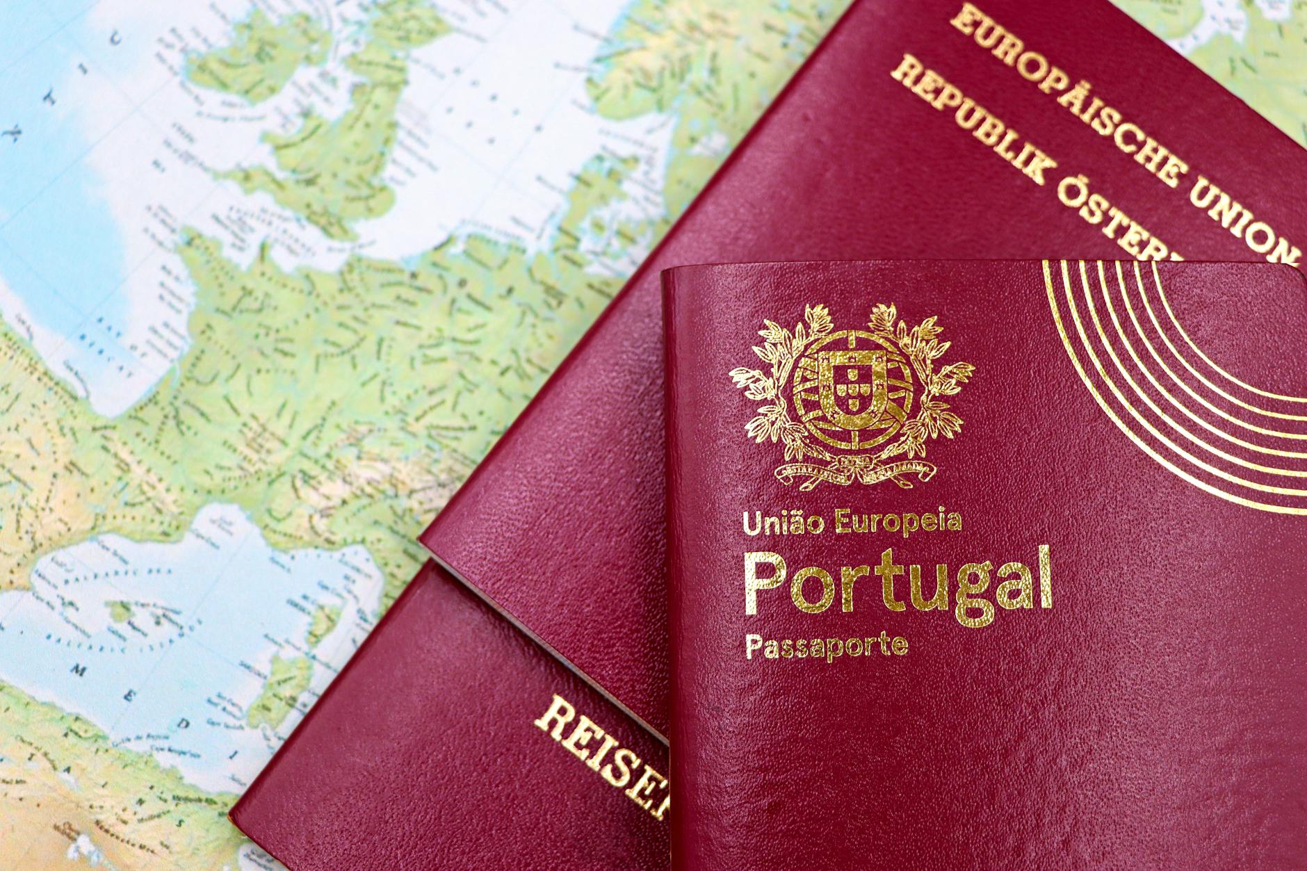Open passport with travel documents and visa application papers on desk