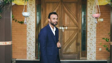 Professional business suit hanging in a closet, representing executive wardrobe selection