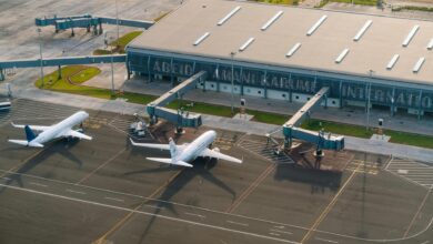 Modern airport terminal interior with travelers and seating areas