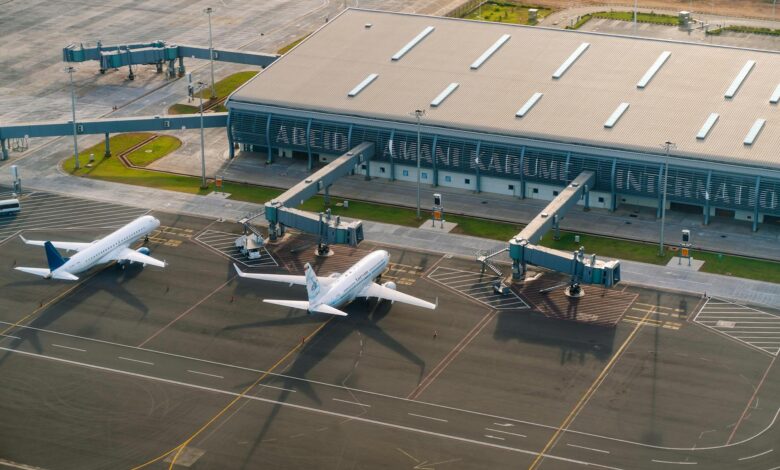 Modern airport terminal interior with travelers and seating areas