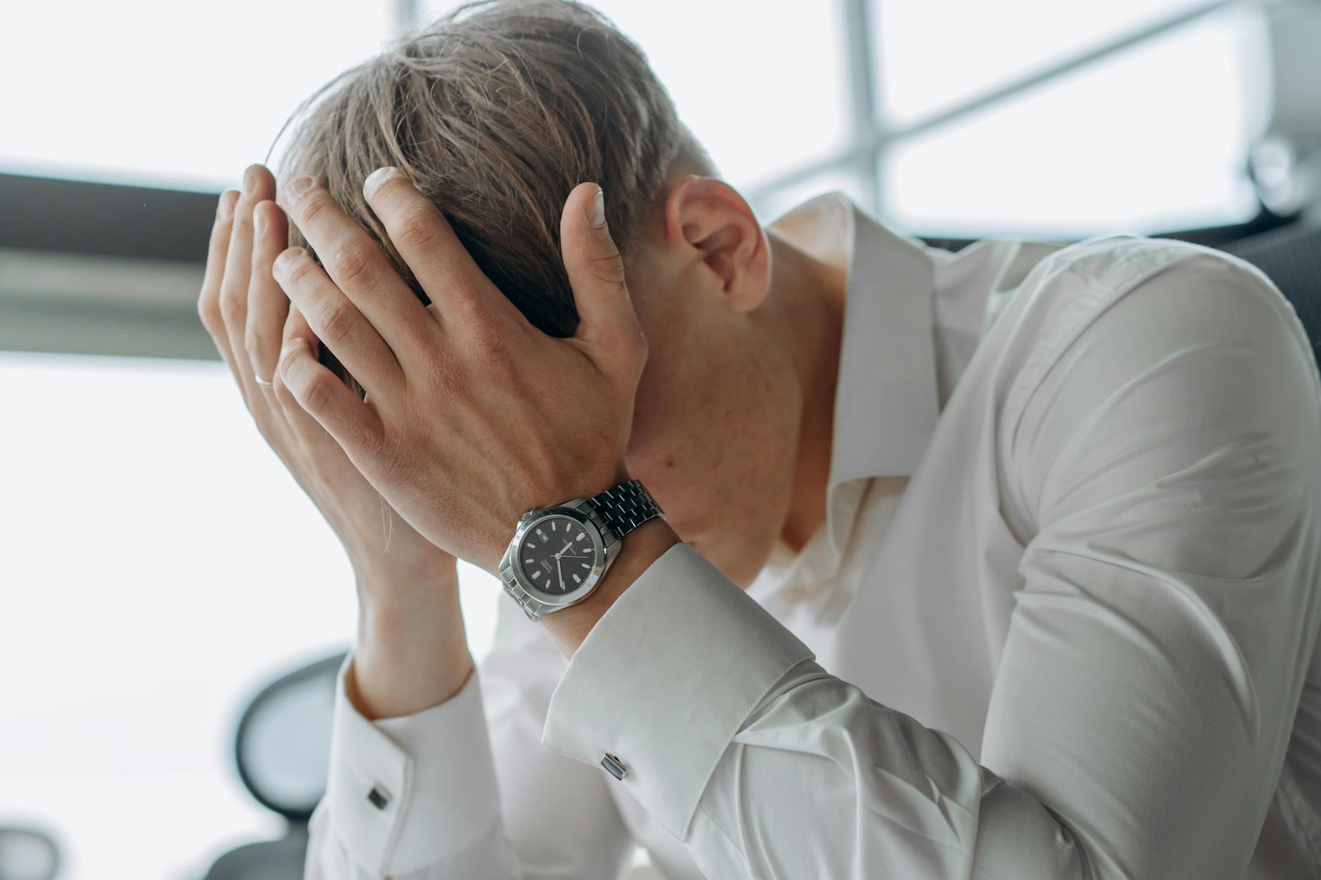 Stressed business executive looking at multiple devices and screens