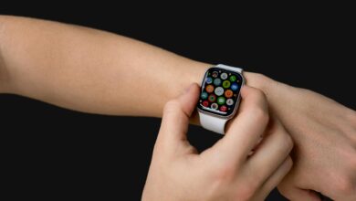 Person wearing smartwatch checking notifications on their wrist at an airport