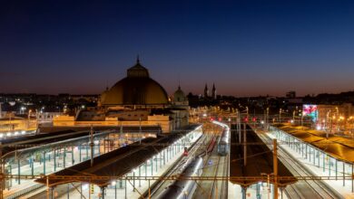 Modern train station platform at night with high-speed train