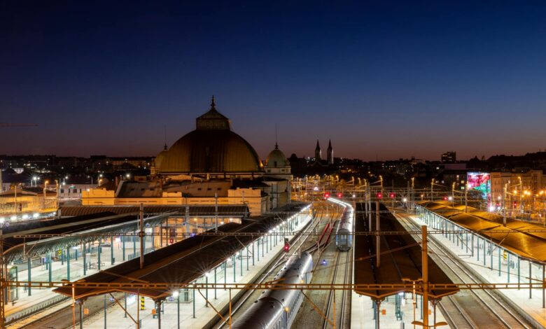 Modern train station platform at night with high-speed train