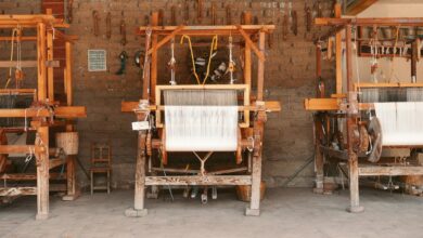 Traditional wooden weaving loom with colorful threads in indigenous workshop setting