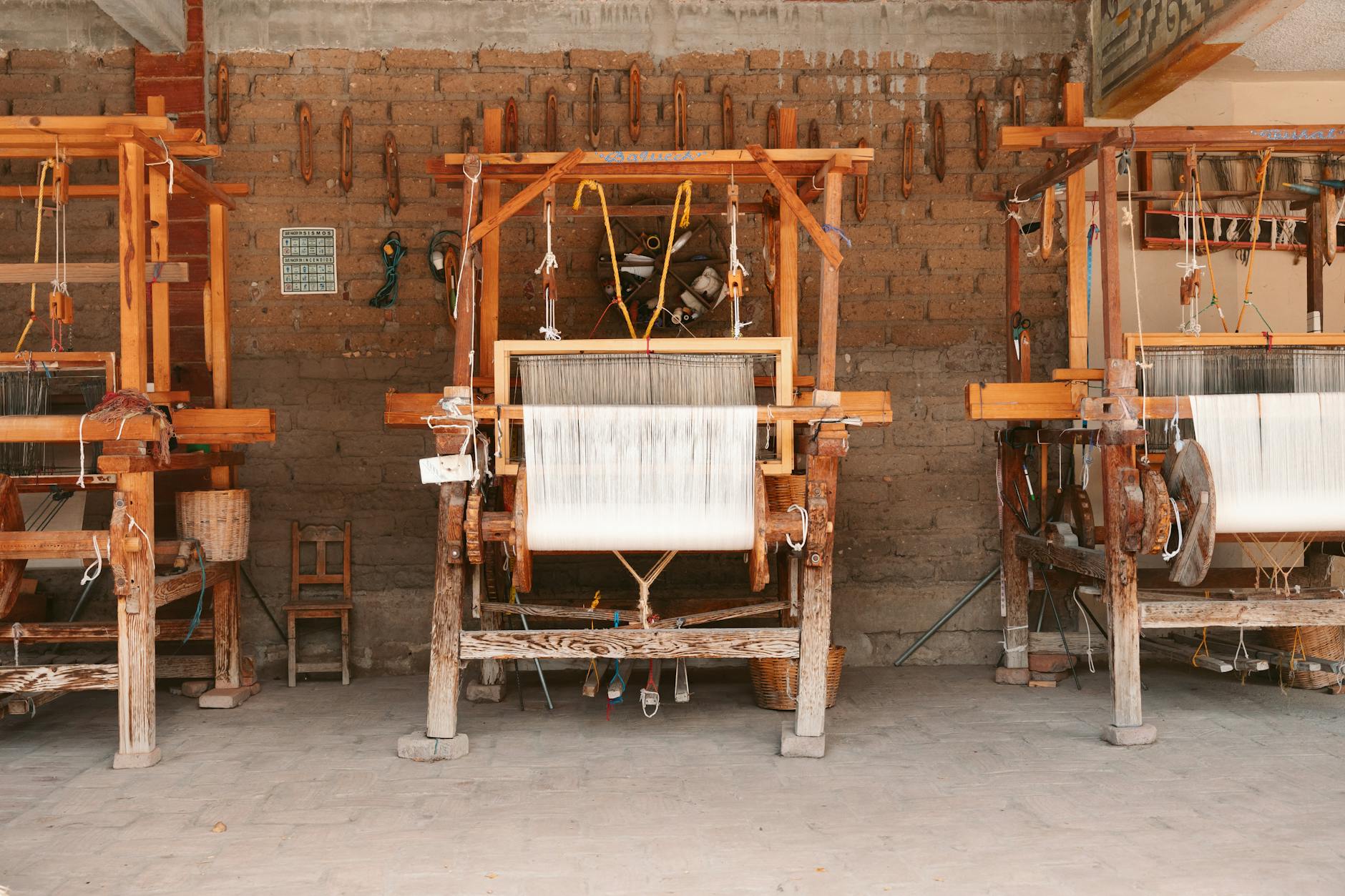 Traditional wooden weaving loom with colorful threads in indigenous workshop setting