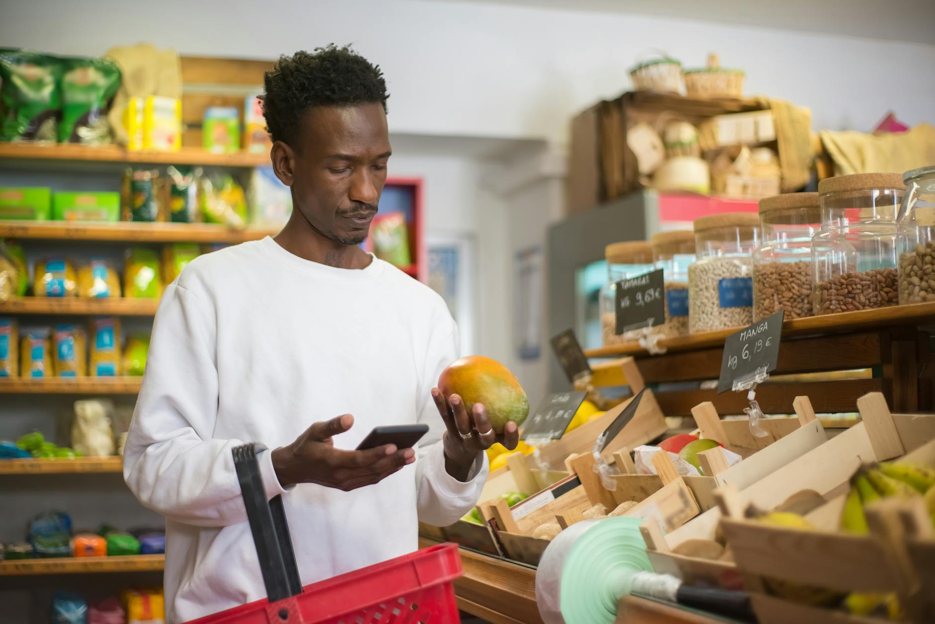 Person using smartphone in grocery store aisle
