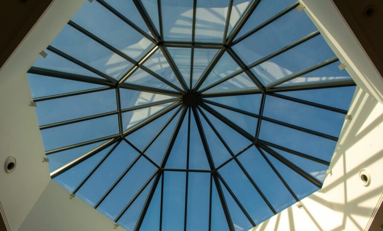 Transparent glass dome structure against snowy mountain landscape