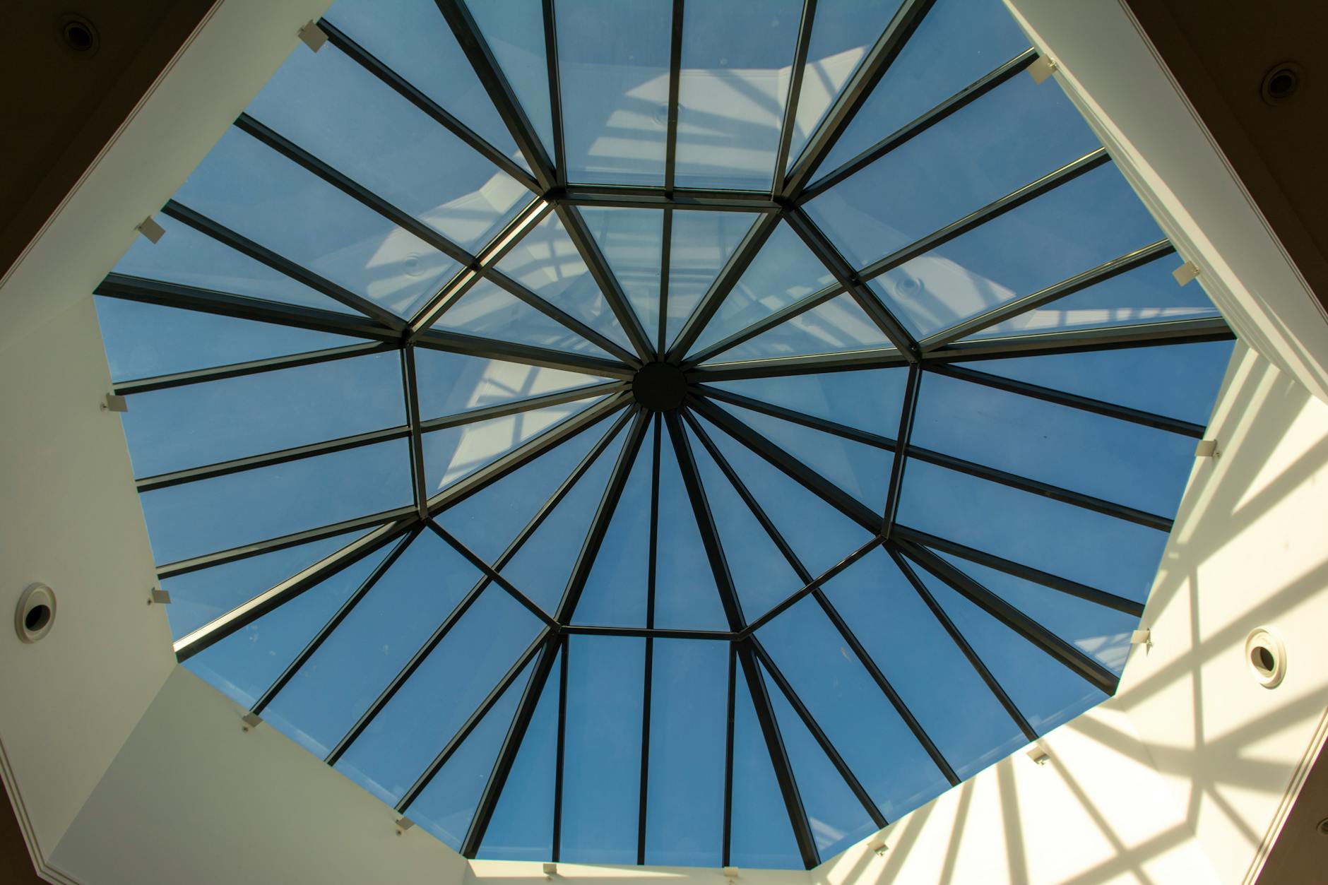 Transparent glass dome structure against snowy mountain landscape
