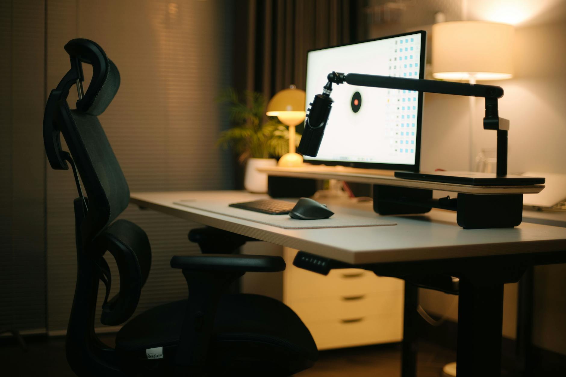 Modern home office with ergonomic desk setup and professional lighting
