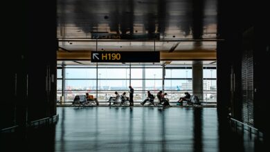 Modern airport gate area with seating and departure screens