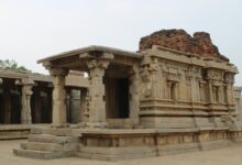 Silhouette of ancient temple structure against darkening sky at twilight
