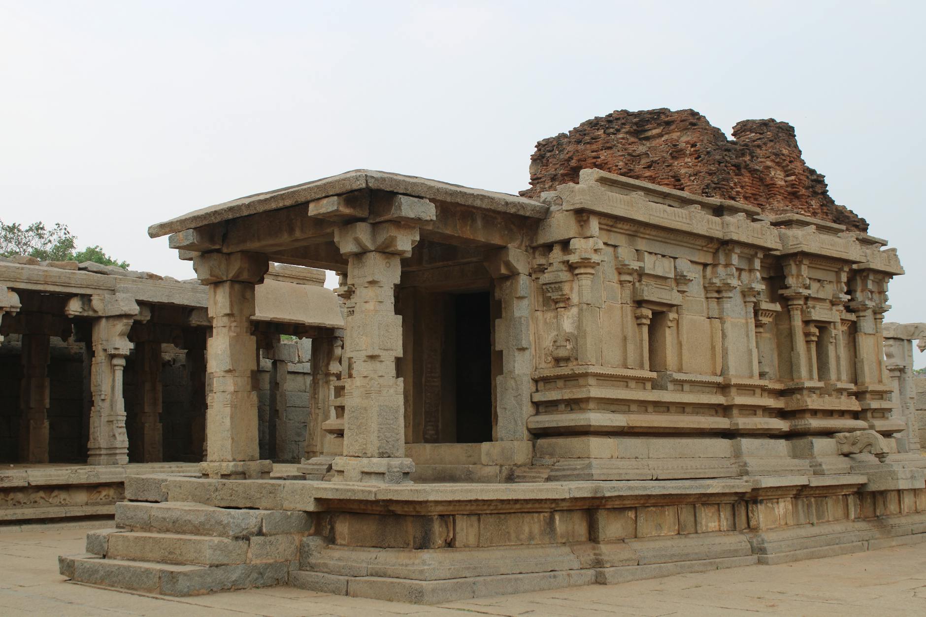 Silhouette of ancient temple structure against darkening sky at twilight