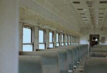 Interior of a modern train car with windows showing scenic countryside views
