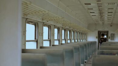 Interior of a modern train car with windows showing scenic countryside views