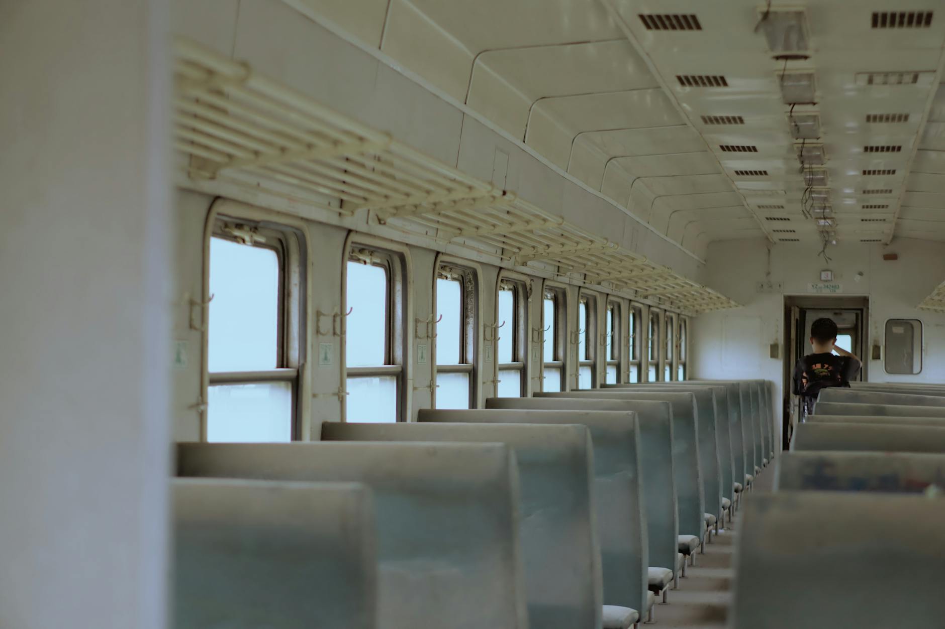 Interior of a modern train car with windows showing scenic countryside views