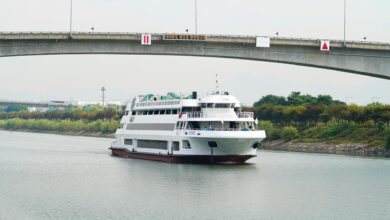 Modern river cruise ship docked along European waterway with passengers boarding