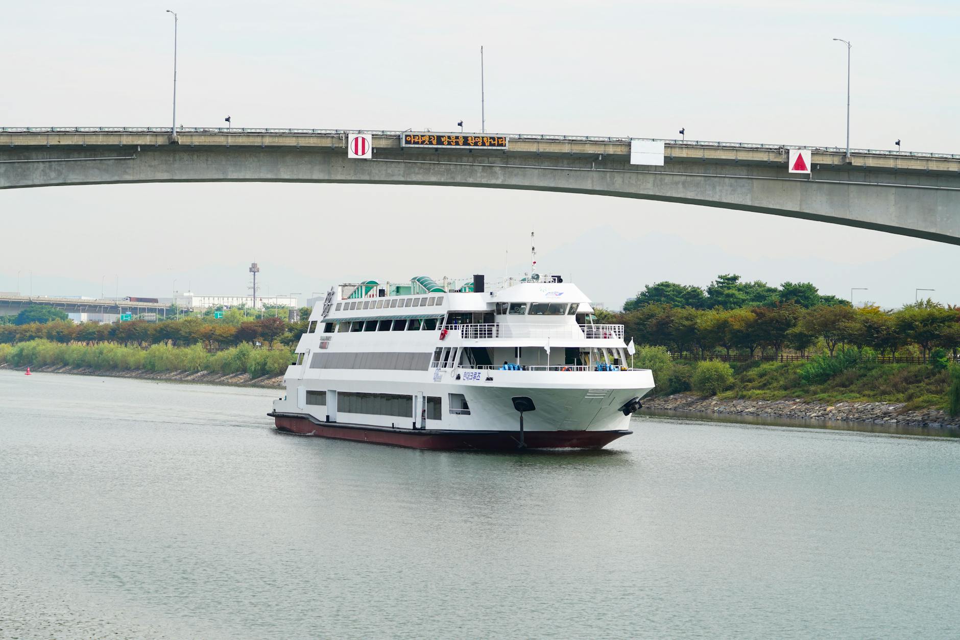 Modern river cruise ship docked along European waterway with passengers boarding