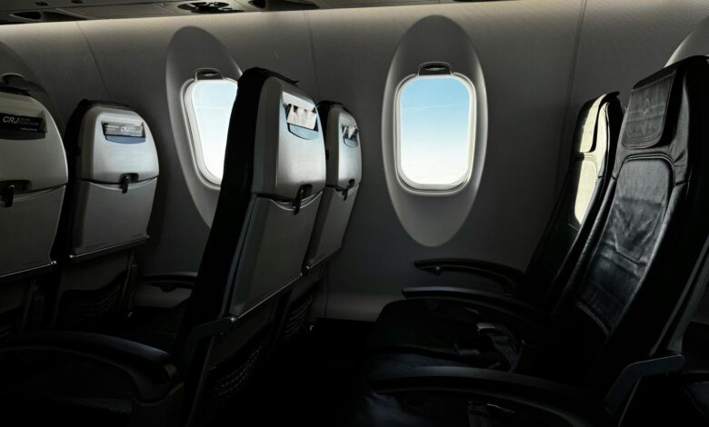 Modern airplane cabin interior showing premium economy seating with extra legroom and enhanced amenities