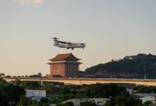 Commercial airplane flying over luxury hotel resort complex