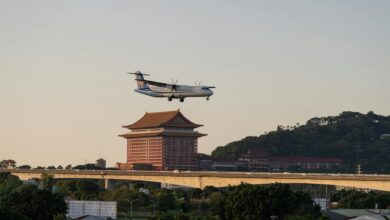Commercial airplane flying over luxury hotel resort complex