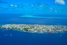 Aerial view of tropical islands surrounded by blue water showing remote island chain geography