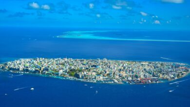 Aerial view of tropical islands surrounded by blue water showing remote island chain geography