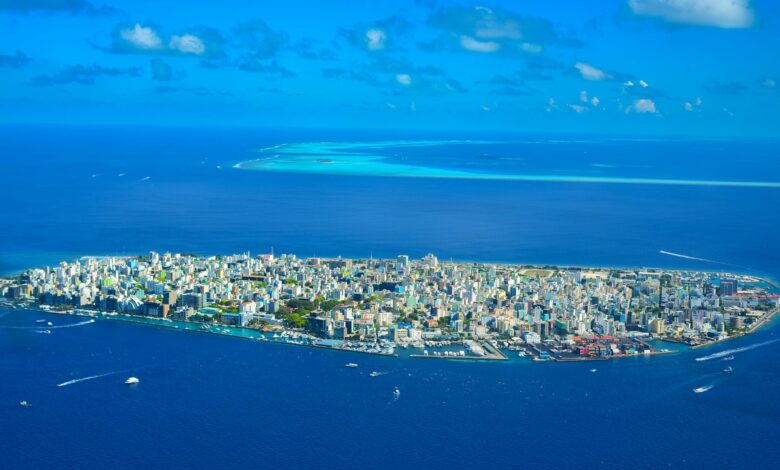 Aerial view of tropical islands surrounded by blue water showing remote island chain geography