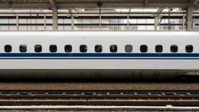 Modern Japanese bullet train traveling through snowy mountain landscape