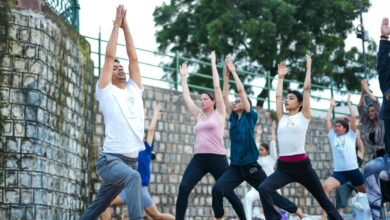 Corporate team practicing yoga together in an outdoor natural setting during a wellness retreat