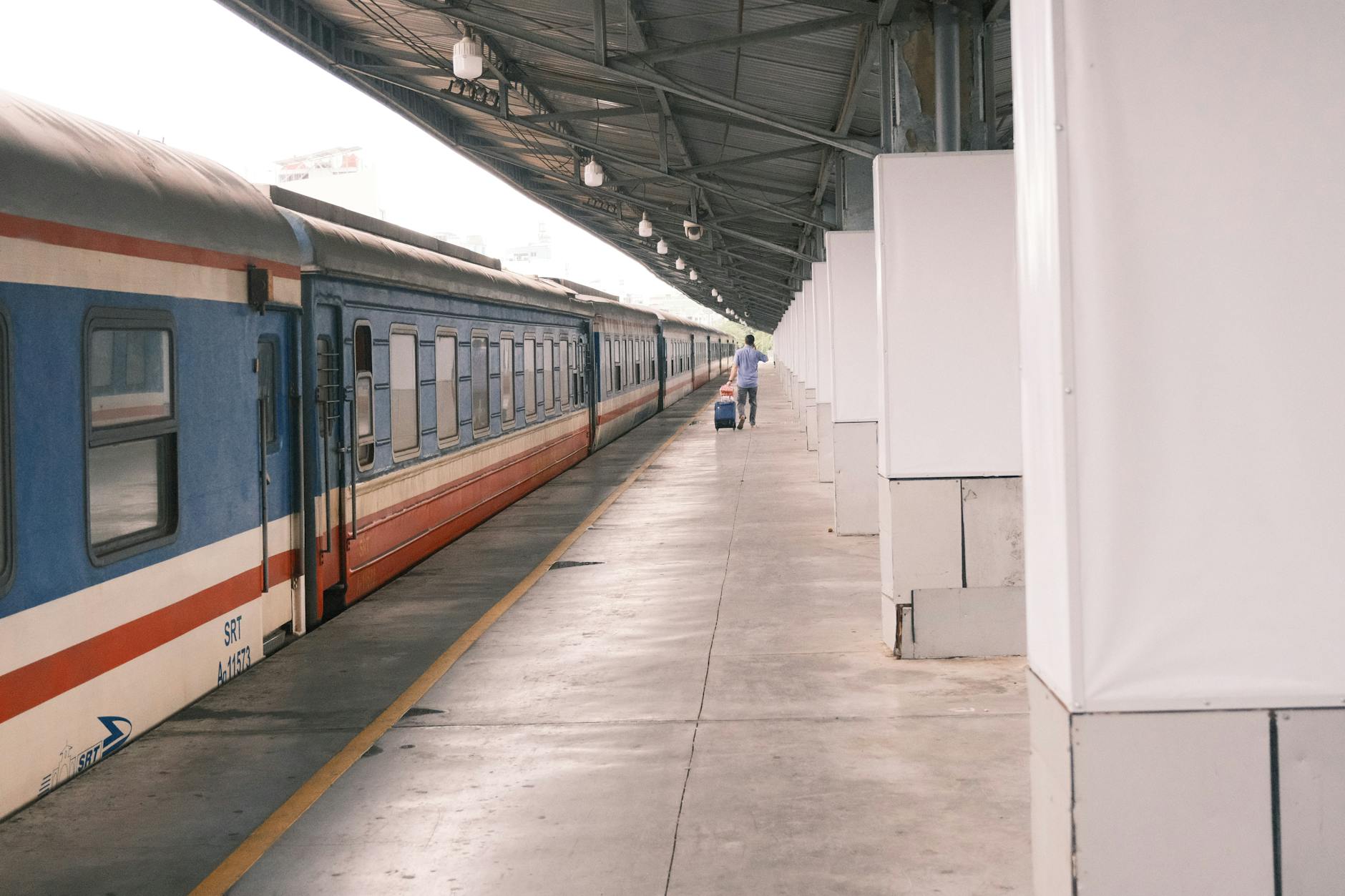 European train station platform with travelers waiting for departure