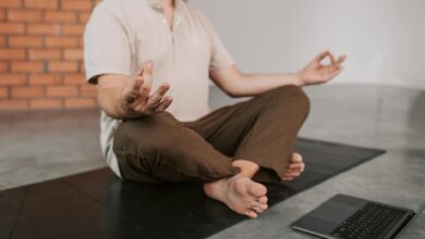 Professional man in business attire meditating peacefully outdoors