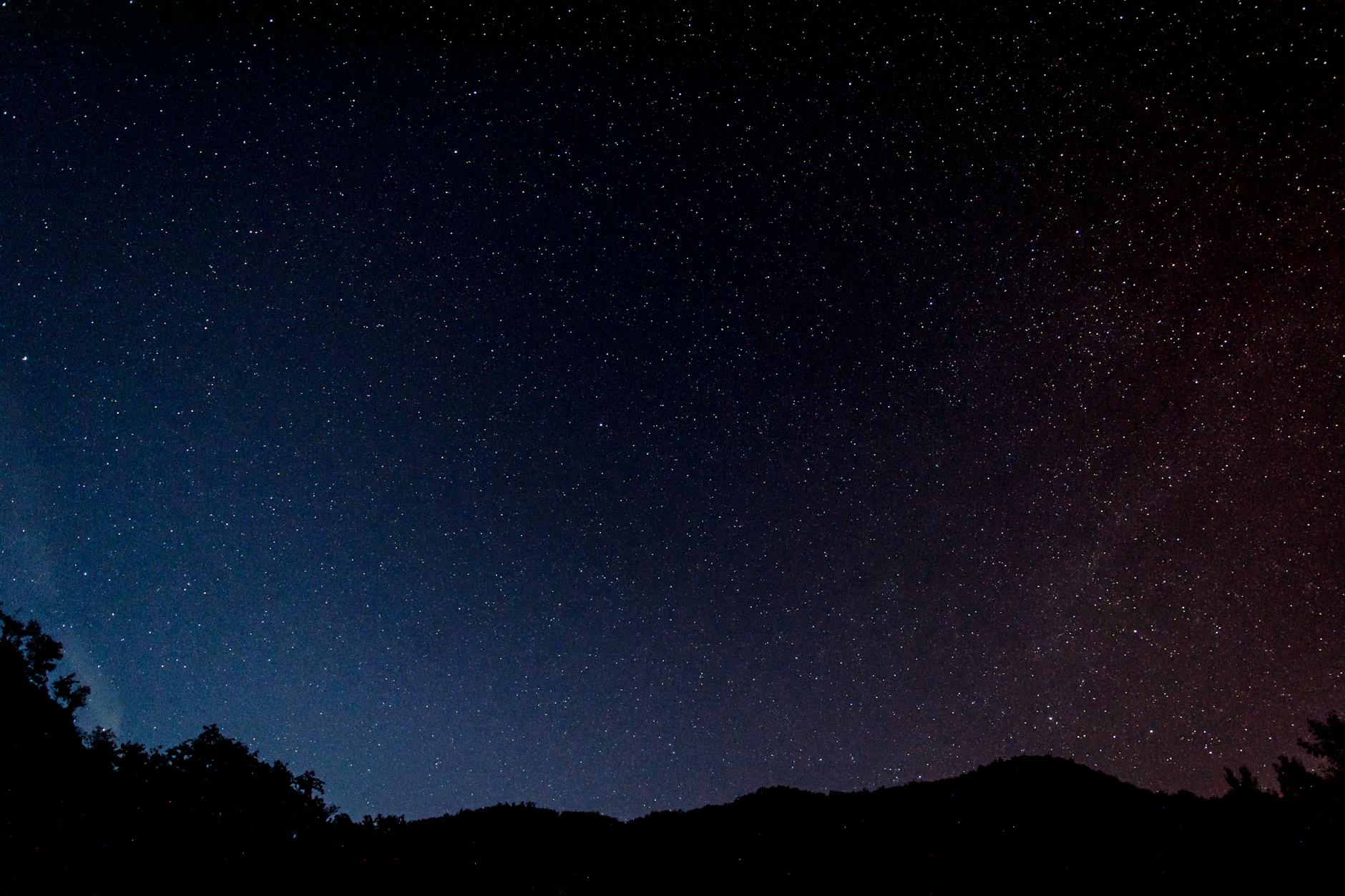 Starry night sky over rural landscape showing clear celestial views