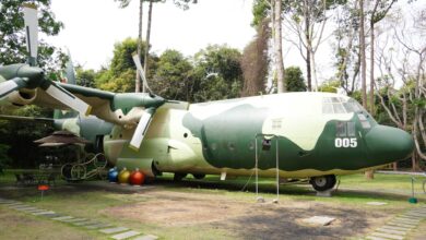 Commercial airplane parked near modern hotel building showing travel industry partnership