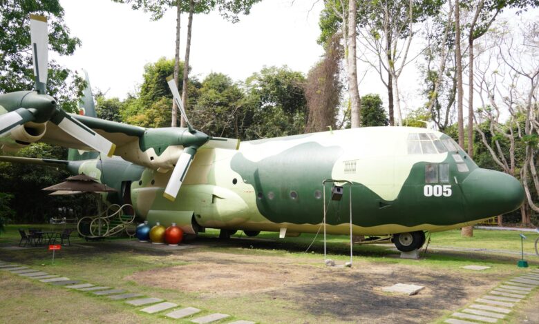 Commercial airplane parked near modern hotel building showing travel industry partnership