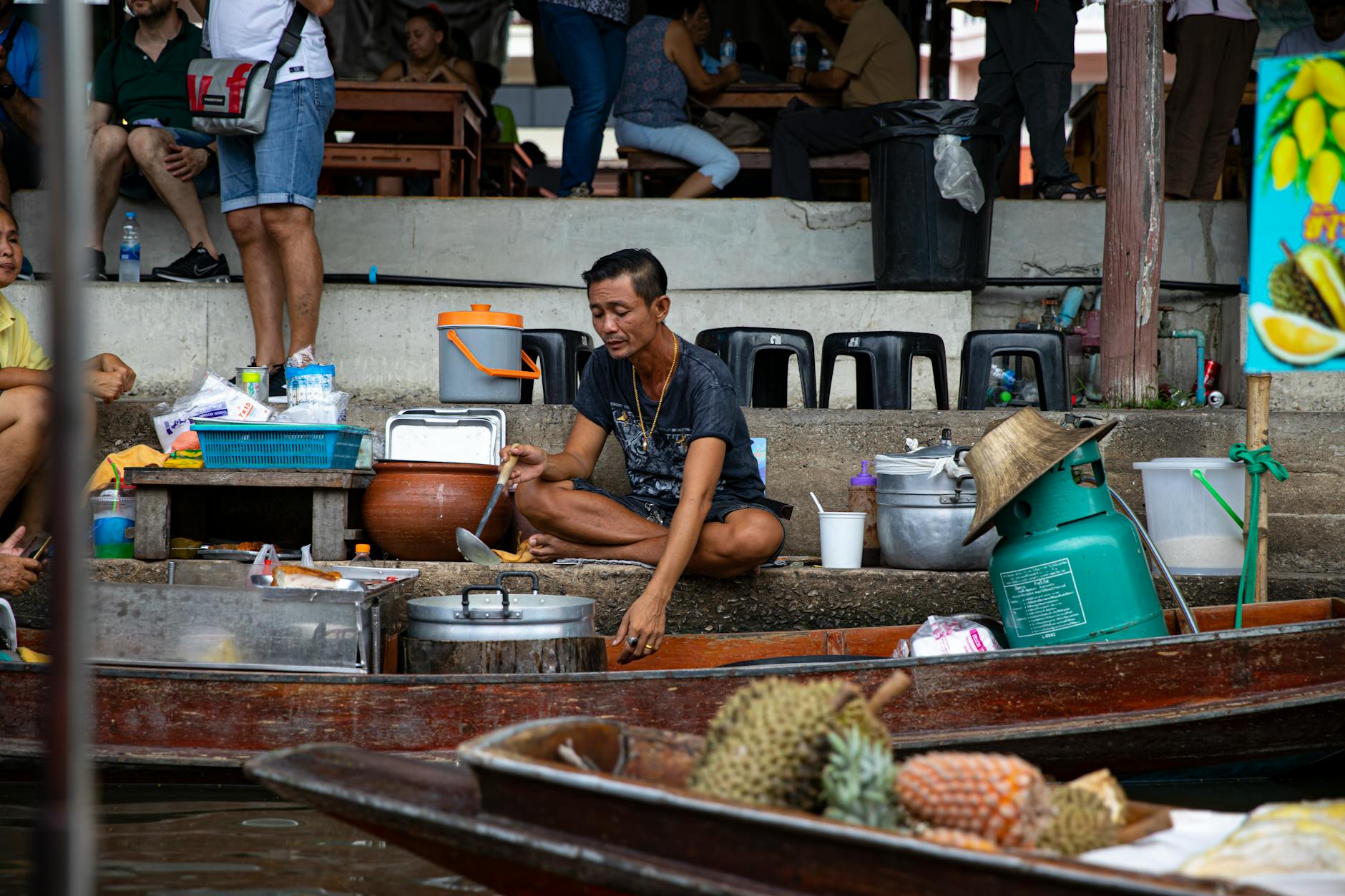 Traditional Vietnamese floating market with vendors selling fresh produce from wooden boats on river water