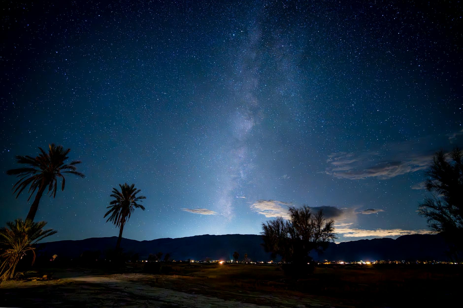 Starry night sky over desert landscape with clear visibility of celestial objects