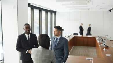 Professional business meeting with executives around conference table in modern office