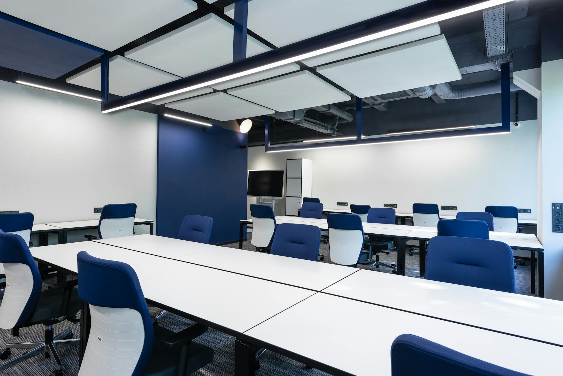 Modern office space with blue accent lighting and contemporary furniture
