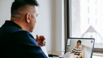 Professional businesswoman participating in a video conference call on laptop