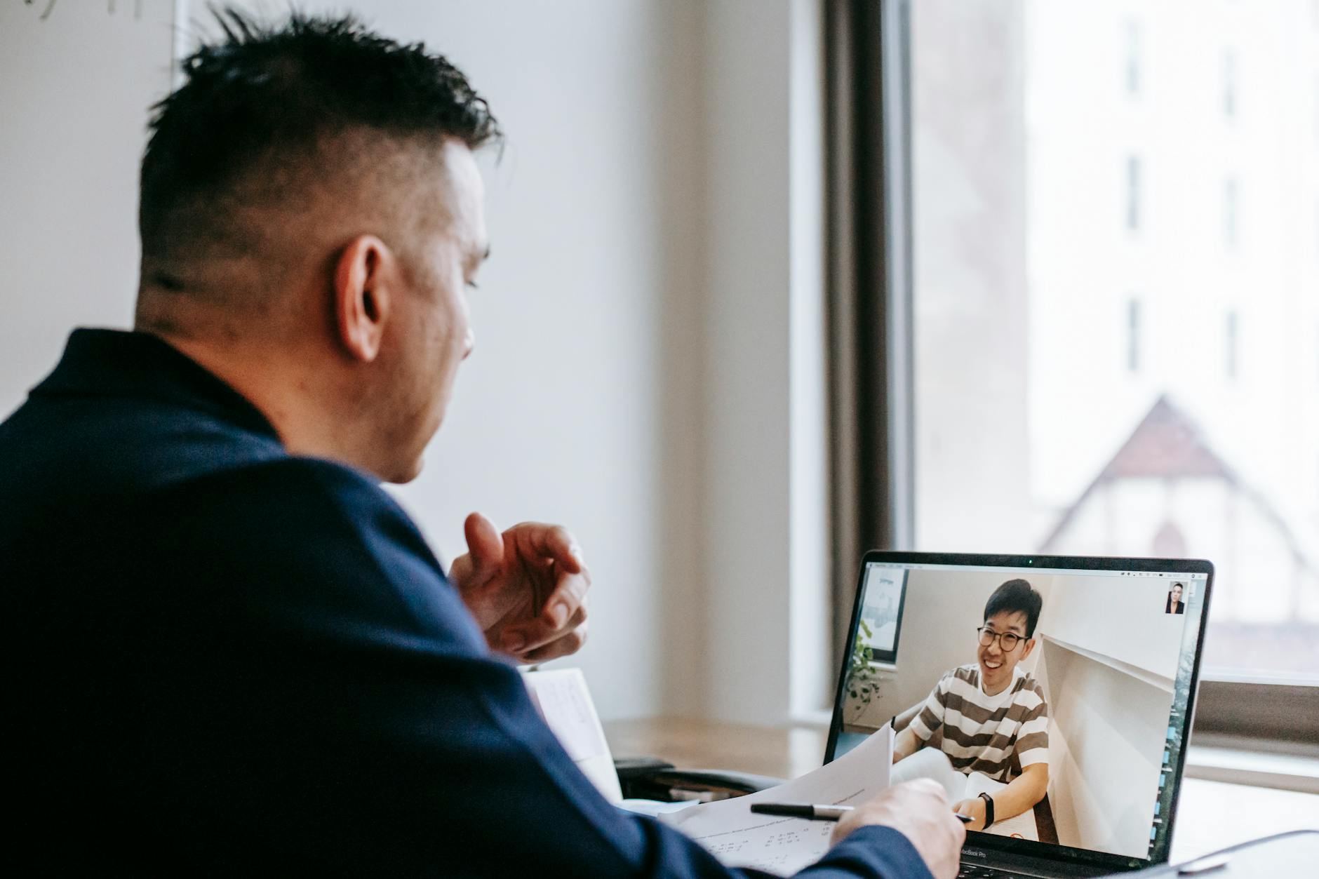 Professional businesswoman participating in a video conference call on laptop