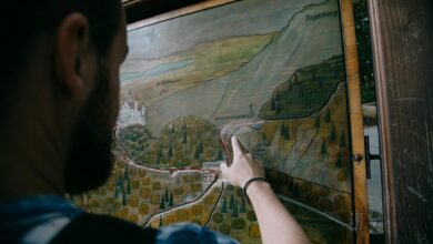 Tourist holding a paper map while exploring a city street